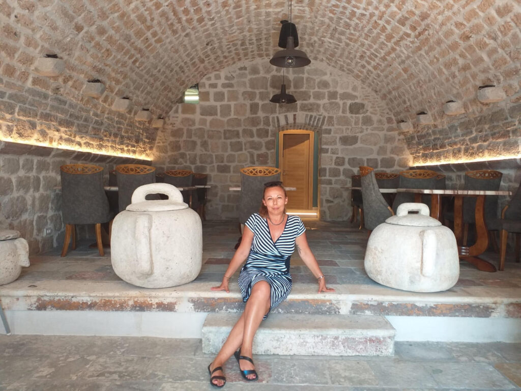 a woman sitting on a stone staircase in Dalmacja - Chorwacja